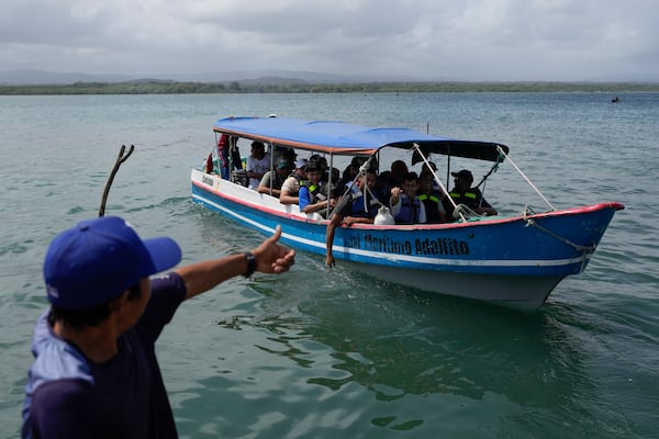 A boat departs to Colombia from Gardi Sugdub on Panama's Caribbean coast, Sunday, Feb. 23, 2025, carrying Venezuelan migrants on their way back from southern Mexico after giving up hopes of reaching the U.S. as President Trump's cracks down on migration.(AP Photo/Matias Delacroix)