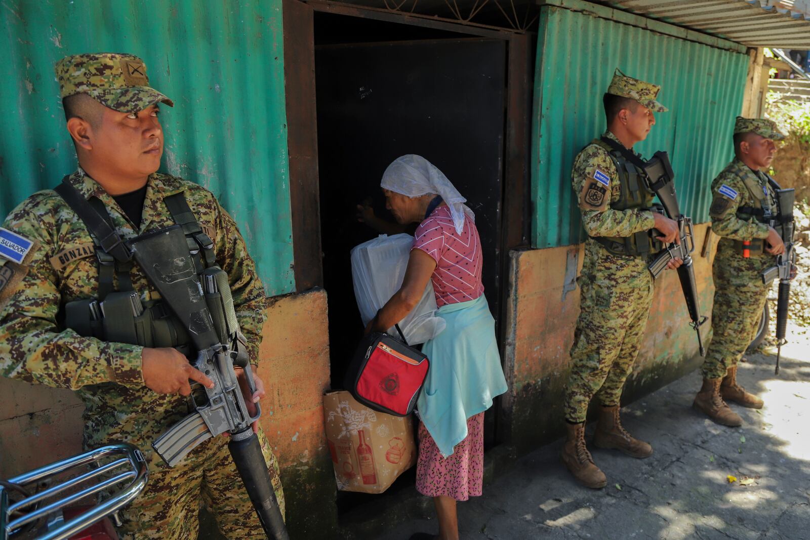 Salvadoran soldiers surveil a street in the 10 de Octubre neighborhood during a government deployment of soldiers and police to crack down on gangs in San Marcos, El Salvador, Monday, Oct. 28, 2024. (AP Photo/Salvador Melendez)