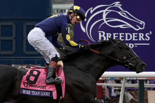 Jose Ortiz reacts after riding More Than Looks to victory in the Breeders' Cup Mile horse race in Del Mar, Calif., Saturday, Nov. 2, 2024. (AP Photo/Gregory Bull)