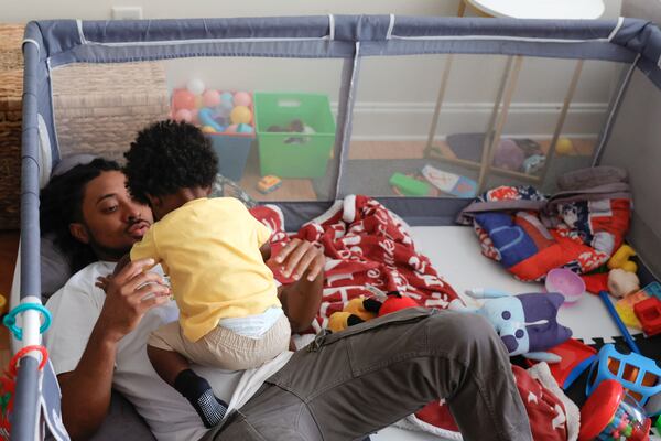 Atlanta rapper Deante Hitchcock plays with his son Otto, 1, at his home in Decatur on Monday, May 1, 2023.  (Natrice Miller/natrice.miller@ajc.com)