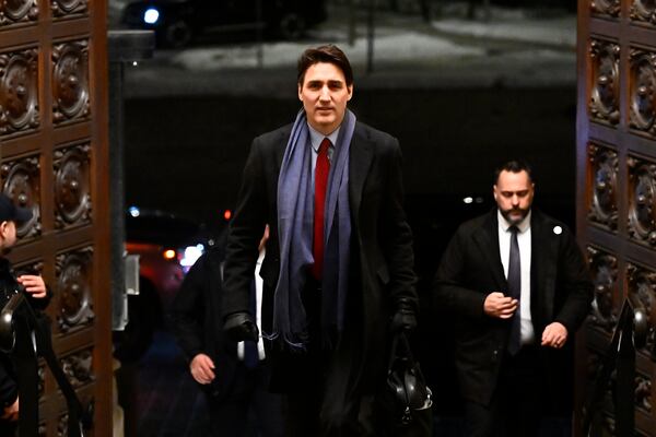 Canada's Prime Minister Justin Trudeau arrives to address media following the imposition of a raft of tariffs by U.S. President Donald Trump against Canada, Mexico and China, in Ottawa, Saturday, Feb. 1, 2025. (Justin Tang/The Canadian Press via AP)