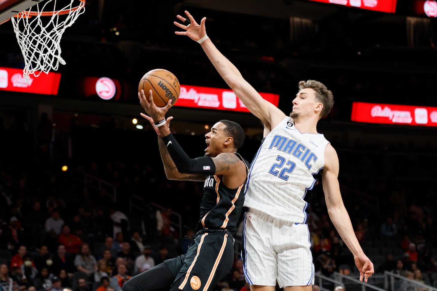 Hawks guard Dejounte Murray attempts a shot against Magic forward Franz Wagner during the first half Monday night in Atlanta. (Miguel Martinez / miguel.martinezjimenez@ajc.com)