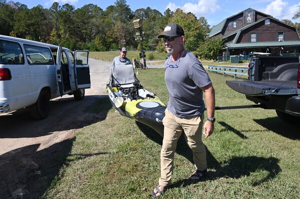 Scott Ellington (foreground) and his friend Craig Henke prepare for fishing in the Flint River at Flint River Outdoor Center, Thursday, Oct. 19, 2023, near Thomaston. A legal battle over property rights and fishing on the Flint River could have implications for public access to waterways across the state.  (Hyosub Shin / Hyosub.Shin@ajc.com)