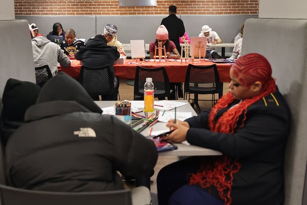 Students spend time in the common area inside of At Promise Youth & Community Center South in Atlanta on Feb. 12. The center was created to give teens and young adults opportunities to get off the streets and explore other outlets and careers. (Natrice Miller/ AJC)