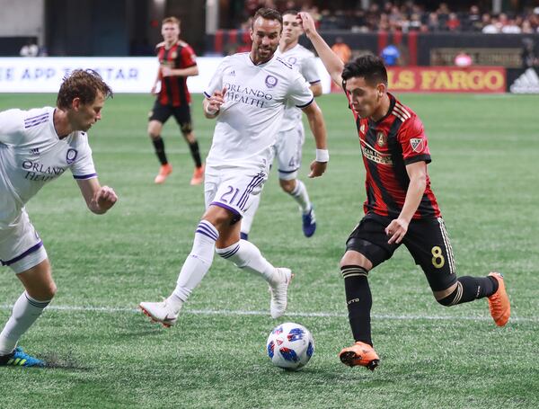 June 30, 2018 Atlanta: Atlanta United Ezequiel Barco works against two Orlando City defenders during the second half in a MLS soccer match on Saturday, June 30, 2018, in Atlanta.     Curtis Compton/ccompton@ajc.com