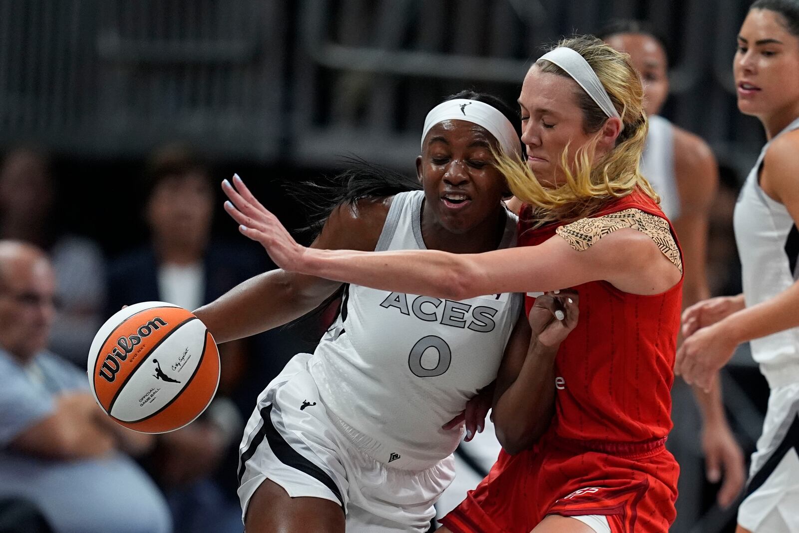 Las Vegas Aces' Jackie Young (0) is defended by Indiana Fever's Lexie Hull during the first half of a WNBA basketball game, Wednesday, Sept. 11, 2024, in Indianapolis. (AP Photo/Darron Cummings)