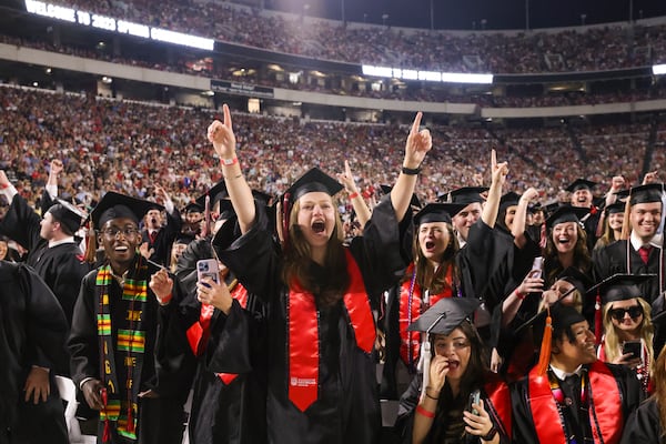 University of Georgia students of the C. Herman and Mary Virginia Terry College of Business react as their degrees are conferred during the Spring Undergraduate Commencement at Sanford Stadium, Friday, May 12, 2023, in Athens, Ga. (Jason Getz / Jason.Getz@ajc.com)