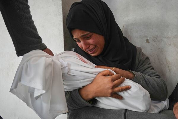 Amani Abu Aker holds the body of her 2-year-old niece Salma, killed during an Israeli army strike, before their burial at the Baptist hospital in Gaza City, Monday March 24, 2025.(AP Photo/Jehad Alshrafi)