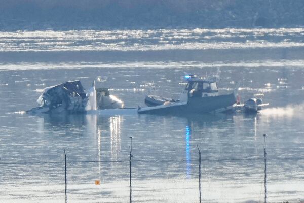 Search and rescue efforts are seen around a wreckage site in the Potomac River from Ronald Reagan Washington National Airport, early Thursday morning, Jan. 30, 2025, in Arlington, Va. (AP Photo/Mark Schiefelbein)