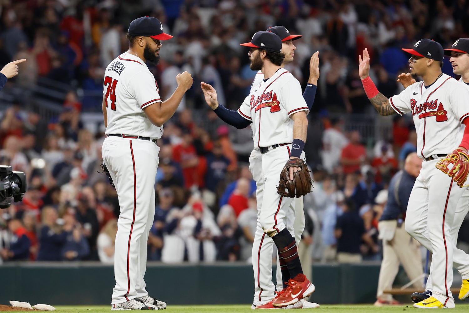 Braves shortstop Dansby Swanson (7) high-five relief pitcher Kenley Jansen after they beat the New York Mets 4-2 at Truist Park on Saturday, Oct. 1, 2022. Miguel Martinez / miguel.martinezjimenez@ajc.com