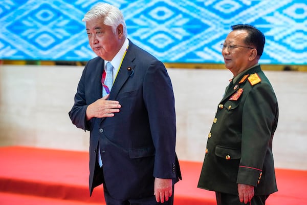 Japanese Defense Minister Gen Nakatani, left, gestures as Laos' Defence Minister Chansamone Chanyalath stands by during the Association of Southeast Asian Nations (ASEAN) defense ministers' meeting in Vientiane, Laos, Thursday, Nov. 21, 2024. (AP Photo/Anupam Nath)