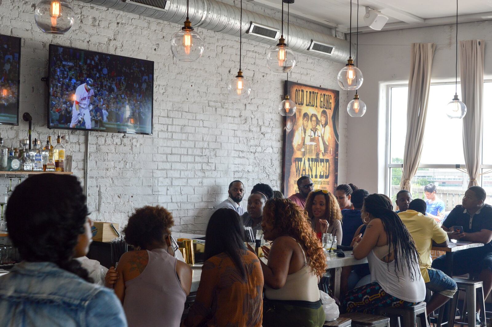 The bar area at Old Lady Gang features large windows and some family-style seating. CONTRIBUTED BY HENRI HOLLIS