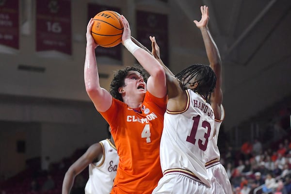 Clemson forward Ian Schieffelin (4) takes a shot at the basket as Boston College guard Donald Hand Jr. (13) defends in the first half of an NCAA college basketball game, Wednesday, March 5, 2025, in Boston. (AP Photo/Steven Senne)