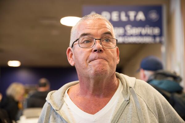 James Flynn, of Acworth, finally got to his elderly mother-in-law Sunday afternoon after she was stranded on the tarmac for hours.  (Alyssa Pointer/AJC)