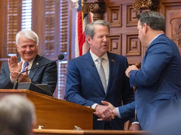 Gov. Brian Kemp shakes hands with Lt. Gov. Burt Jones, right, as Georgia House Speaker Jon Burns, R-Newington, left, looks on following the State of the State address at the House of Representatives in the Capitol in Atlanta on Thursday, January 11, 2024. (Arvin Temkar/arvin.temkar@ajc.com)