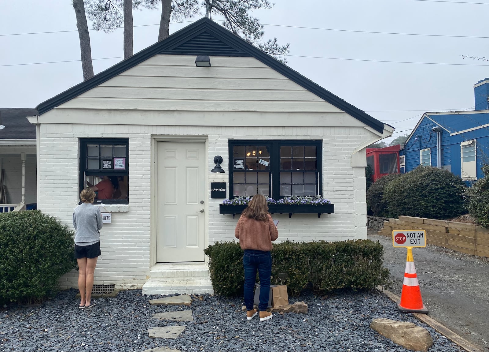 Orders for the Milkdrop Biscuits pop-up are picked up in the rear of the cottage next door to Buttermilk Kitchen in Buckhead. Ligaya Figueras/ligaya.figueras@ajc.com