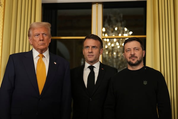 French President Emmanuel Macron, center, poses with President-elect Donald Trump, left, and Ukraine's President Volodymyr Zelenskyy at the Elysee Palace, Saturday, Dec. 7, 2024 in Paris. (AP Photo/Aurelien Morissard)