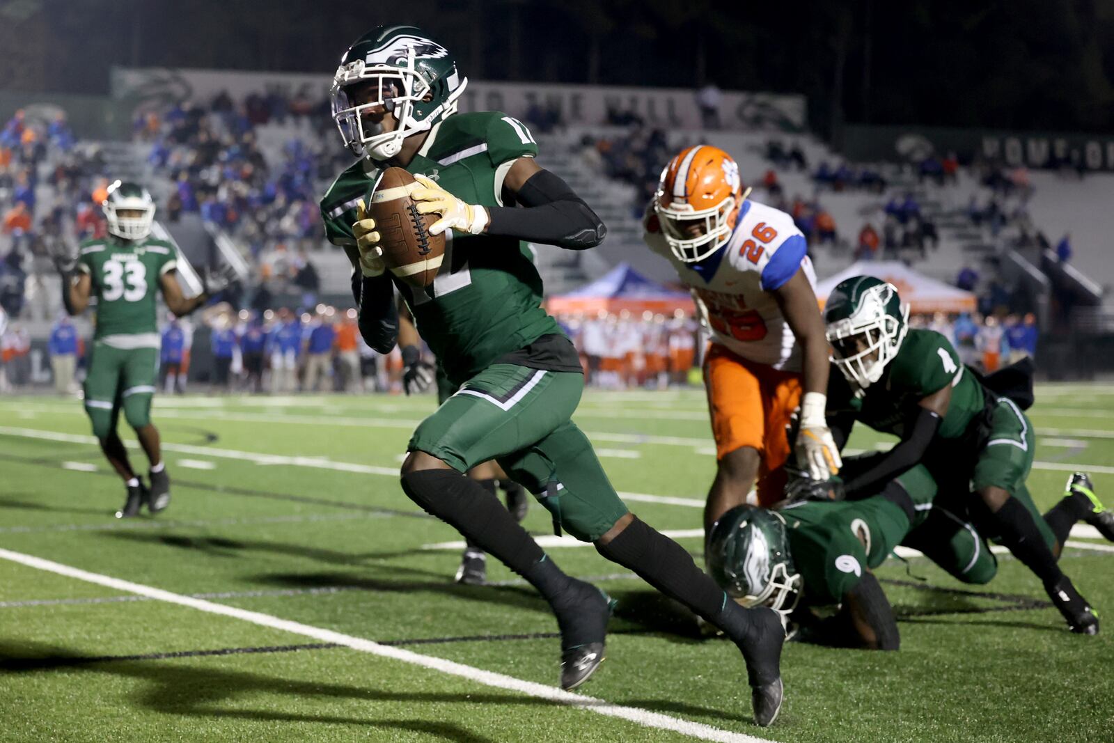 Collins Hill defensive back Travis Hunter (12) returns an interception for a touchdown in the first half against Parkview during the Class 7A quarterfinals game at Collins Hill high school Friday, Dec. 11, 2020, in Suwanee. (Jason Getz/For the AJC)
