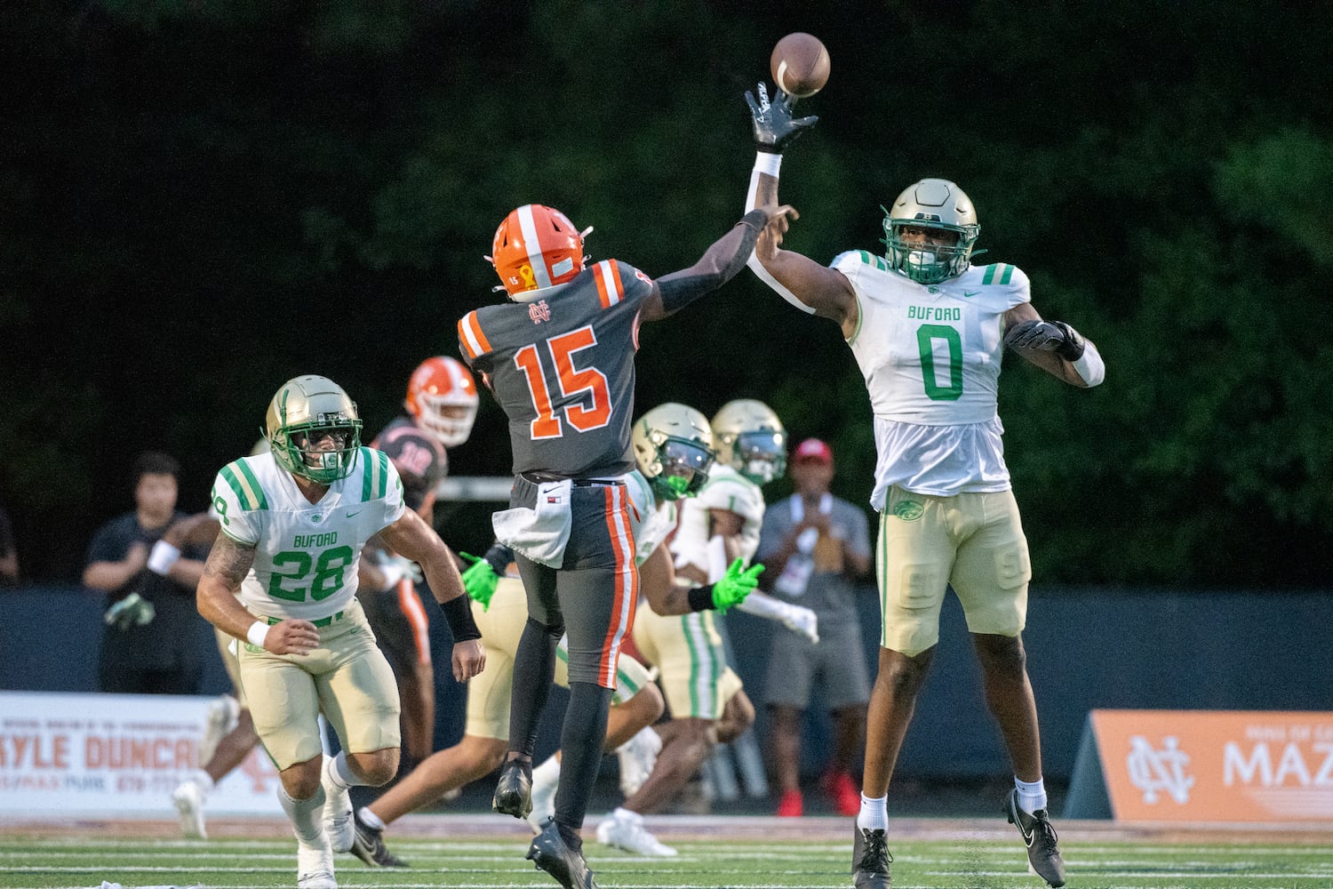 Buford's Eddrick Houston stretches as he tries to deflect a pass during Friday's game at North Cobb. (Jamie Spaar/For the AJC)