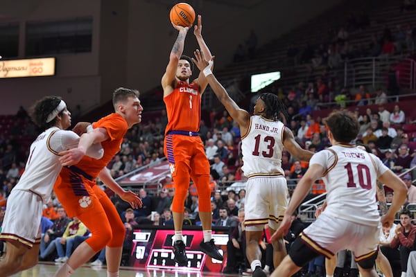 Clemson guard Chase Hunter (1) takes a shot at the basket as Boston College guard Donald Hand Jr. (13) defends in the second half of an NCAA college basketball game, Wednesday, March 5, 2025, in Boston. (AP Photo/Steven Senne)