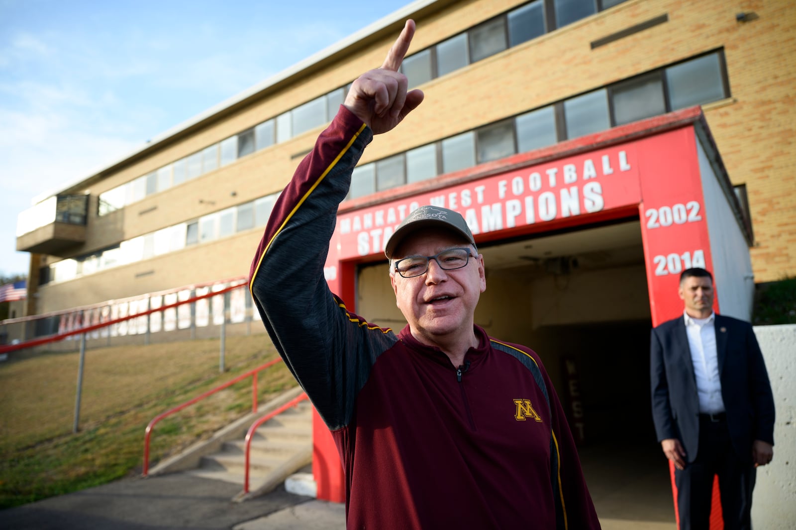 Minnesota Gov. Tim Walz, the Democratic vice presidential nominee,  greets people at Mankato West High School in Minnesota, where he once was a coach.