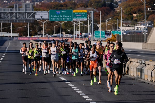 Yuma Morii, right, of Japan, makes his way onto the Verrazzano Narrows bridge with runners in the men's elite division make their way from the start line during the New York City Marathon, Sunday, Nov. 3, 2024, in New York. (AP Photo/Eduardo Munoz Alvarez)