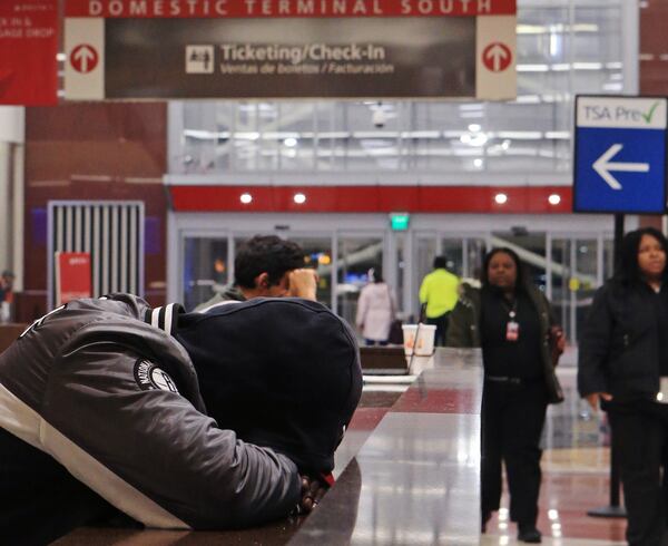 A man sleeps in the domestic terminal of Hartsfield-Jackson International Airport on Friday, February 7, 2020, in Atlanta. Many of Atlanta’s homeless sleep overnight in the airport’s domestic terminal when the city experiences frigid overnight temperatures. (Christina Matacotta/crmatacotta@gmail.com)