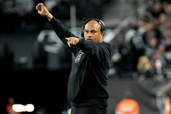 Las Vegas Raiders head coach Antonio Pierce makes a call during the second half of an NFL football game against the Atlanta Falcons, Monday, Dec. 16, 2024, in Las Vegas. (AP Photo/Rick Scuteri)