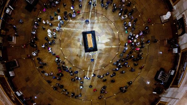 Visitors pay their respects as the casket of Reverend Billy Graham lies in honor at the Rotunda of the U.S. Capitol Building in Washington, Wednesday, Feb. 28, 2018. It's a rare honor for a private citizen to lie in honor at the Capitol. Graham died Wednesday in his sleep at his North Carolina home. He was 99. (AP Photo/Jose Luis Magana)