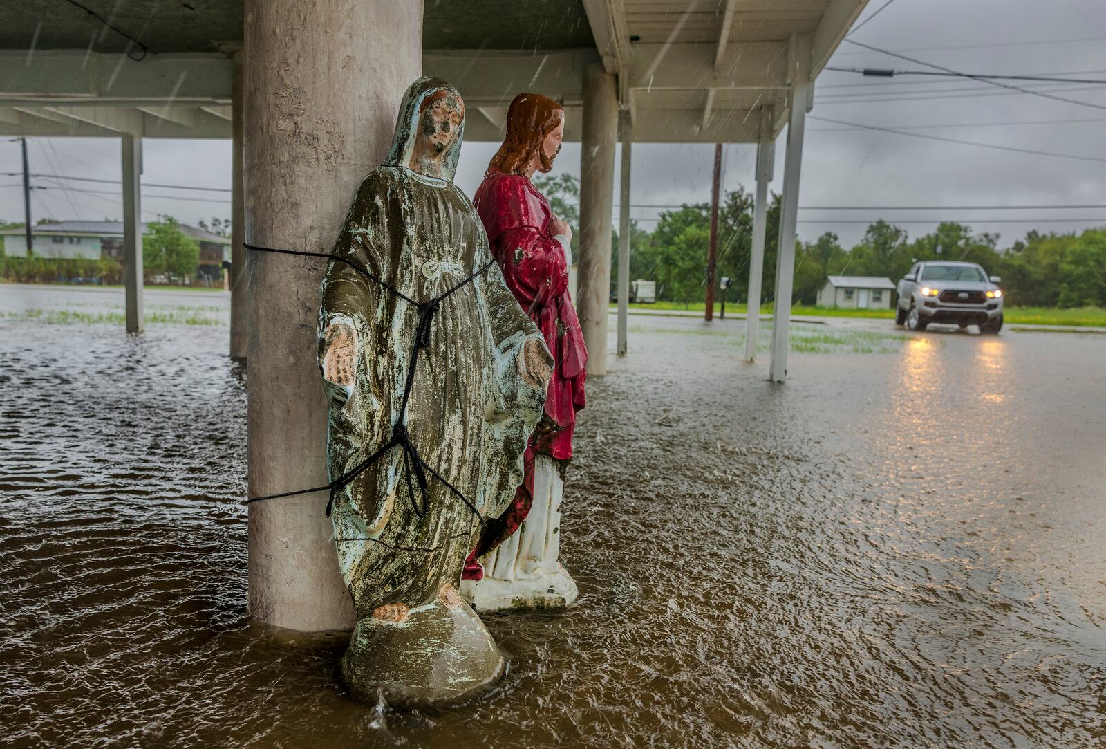 Hurricane Francine floodwater rises around a statue of Mary tied to the support of an elevated home in Terrebonne Parish as the hurricane begins to make landfall along the Louisiana coast on Wednesday, Sept.11, 2024. (Chris Granger/The Times-Picayune/The New Orleans Advocate via AP)