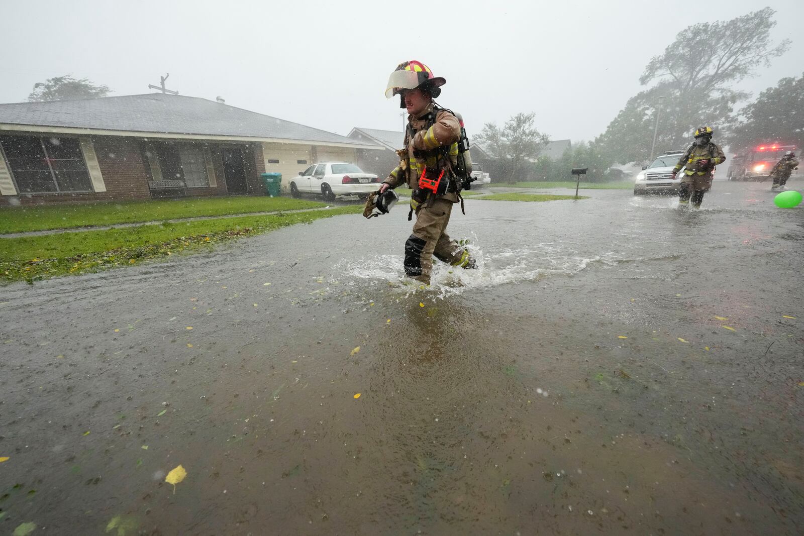 Morgan City firefighters respond to a home fire during Hurricane Francine in Morgan City, La., Wednesday, Sept. 11, 2024. (AP Photo/Gerald Herbert)