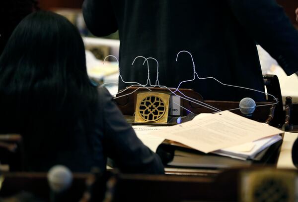 State Rep. Brenda Lopez Romero (left), D - Norcross, brought coat hangers into the House to show opposition to HB 481, which would toughen restrictions on abortions. Bob Andres / bandres@ajc.com