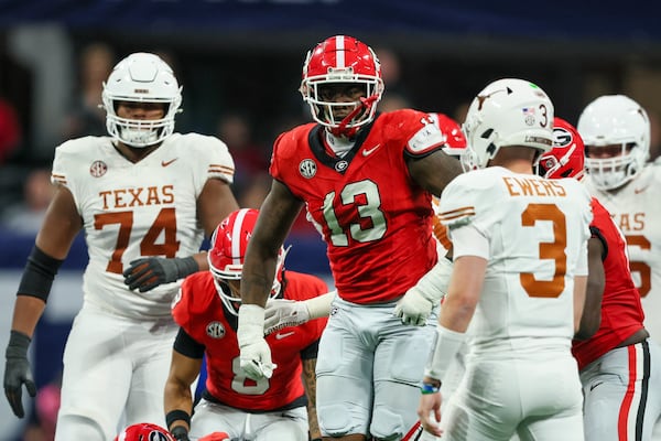 Georgia defensive lineman Mykel Williams (13) reacts after making a tackle as Texas quarterback Quinn Ewers (3) is shown on the play during the 2024 SEC Championship game at Mercedes-Benz Stadium, Saturday, December 7, 2024, in Atlanta. Jason Getz / AJC)
