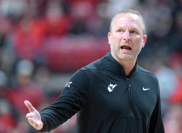 West Virginia head coach Darian DeVries gestures to the referee during the first half of an NCAA college basketball game against Texas Tech, Saturday, Feb. 22, 2025, in Lubbock, Texas. (AP Photo/Annie Rice)