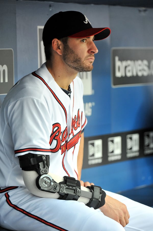 Brandon Beachy after his first TJ surgery. (Hyosub Shin/AJC photo) July 5, 2012 Atlanta - Atlanta Braves pitcher Brandon Beachy watches from the Braves dugout during the home game against the Chicago Cubs at Turner Field in Atlanta on Thursday, July 5, 2012. Brandon Beachy has a partial tear of the ulnar collateral ligament in his pitching elbow, an injury that usually required ligament-transplant surgery and a rehabilitation period of 12-14 months. HYOSUB SHIN / HSHIN@AJC.COM