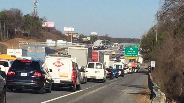 The crash backed up traffic for miles on a busy travel day. JOHN SPINK / JSPINK@AJC.COM