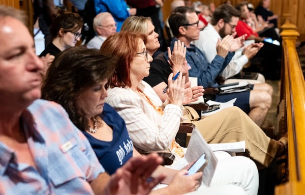 Members of the public applaud Tuesday after the State Election Board gave initial approval to consider a rule expanding the access of poll watchers.