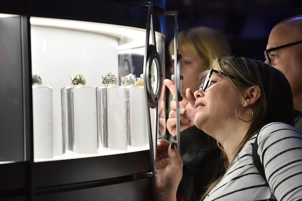 Fans line up to look Super Bowl rings during the Super Bowl Experience in the Georgia World Congress Center on Saturday. HYOSUB SHIN / HSHIN@AJC.COM