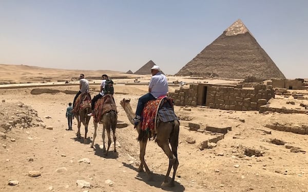 Dallas Mavericks forward Dwight Powell leads his group on a camel tour of Egyptian pyramids while on summer vacation. The group visited King Tutenkamen's pyramid. (Courtesy Dwight Powell)