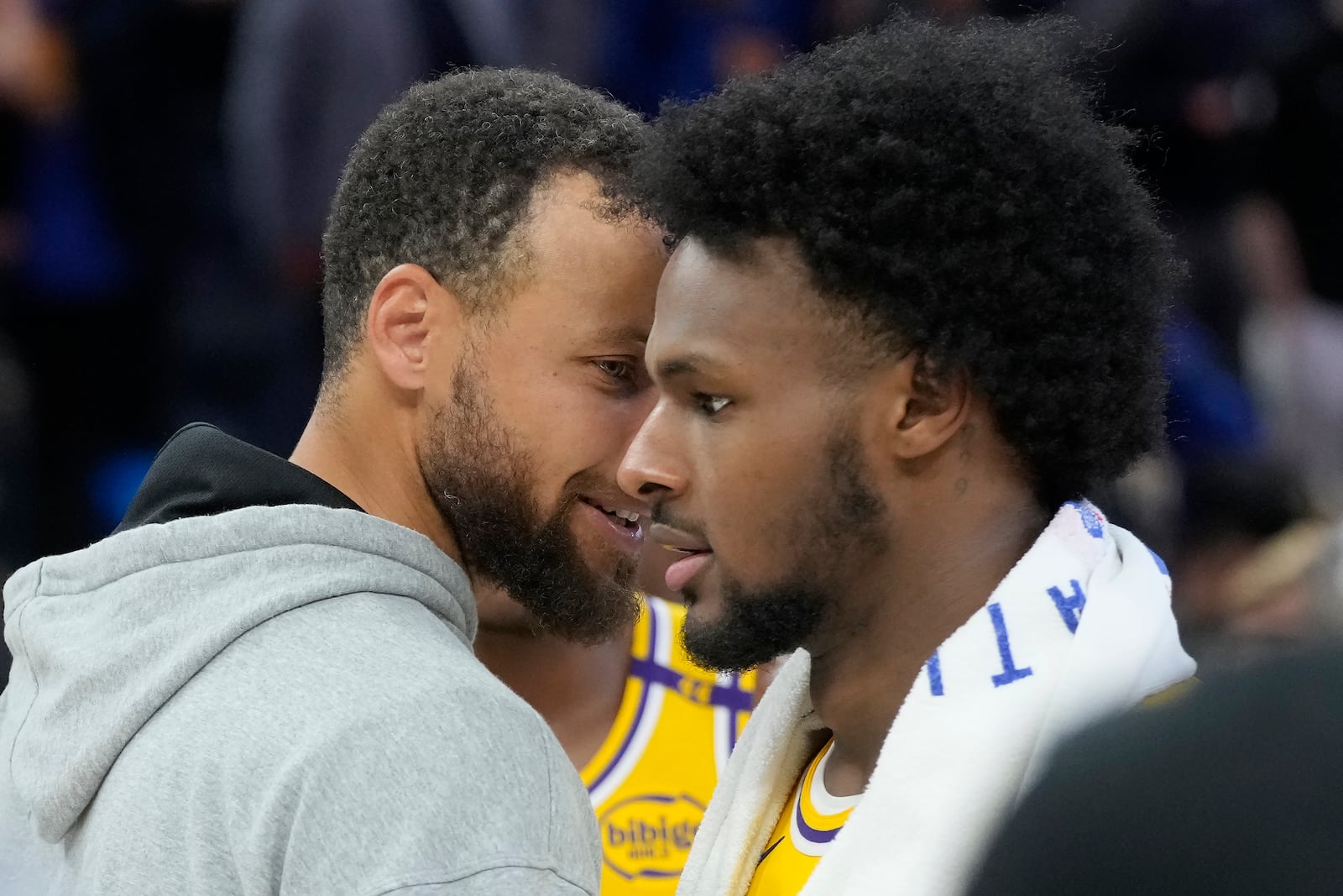 Golden State Warriors guard Stephen Curry, left, talks with Los Angeles Lakers guard Bronny James after an NBA preseason basketball game in San Francisco, Friday, Oct. 18, 2024. (AP Photo/Jeff Chiu)