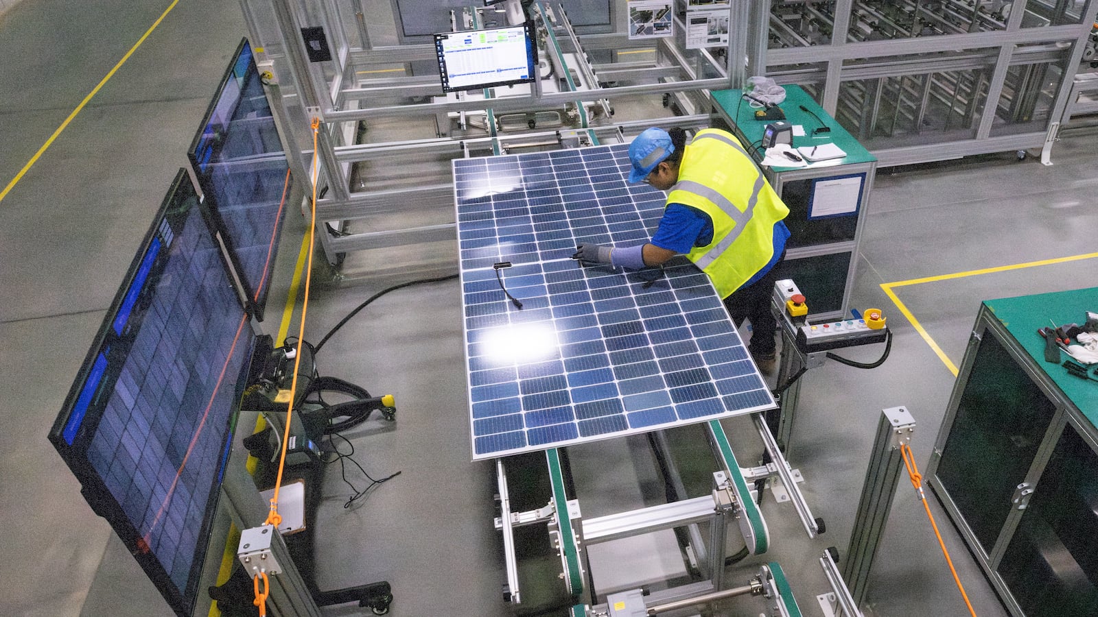 A worker conducts quality performance checks on a freshly assembled solar panel at Qcells' new manufacturing plant in Cartersville. The company has said President Joe Biden’s signature climate and health law, the Inflation Reduction Act, helped persuade it to expand its $2.5 billion footprint in Georgia. Steve Schaefer/ AJC File