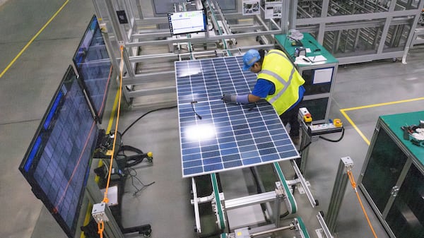 A worker at Qcells new manufacturing factory in Cartersville conducted quality performance checks on a freshly assembled solar panel on April 2, 2024. (Steve Schaefer/steve.schaefer@ajc.com)