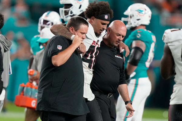 Atlanta Falcons linebacker Bralen Trice (48) is assisted off the field during the first half of a pre season NFL football game against the Miami Dolphins, Friday, Aug. 9, 2024, in Miami Gardens, Fla. (AP Photo/Lynne Sladky)