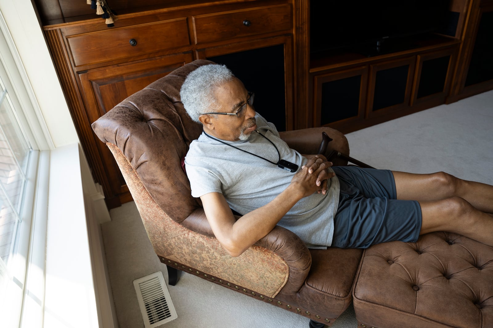 Kamau Rono, battling two different types of cancer, sits at his daughter's home Oct. 8, worried about his ongoing health in light of the BioLab incident. He hasn’t left the house in days, staying indoors as the family navigates the uncertainty of the situation. Olivia Bowdoin for the AJC.