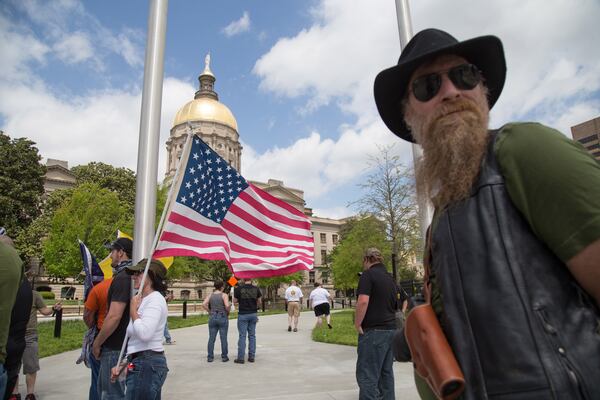 Shawn Zarbrook (right) waits for the start of the gun rights rally at the  Georgia State Capital Saturday, April 14, 2018. Recent protests in the wake of the deadly Parkland, Florida, school shooting have led to concerns about the Second Amendment.  STEVE SCHAEFER / SPECIAL TO THE AJC