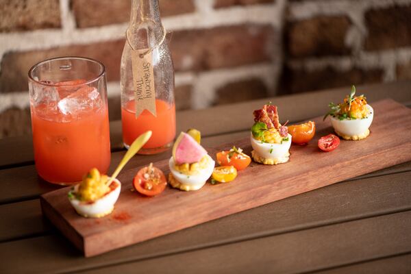 UP on the Roof Humpty Dumpties daily deviled eggs with It's Strawberry Thyme cocktail. (Mia Yakel for The Atlanta Journal-Constitution)