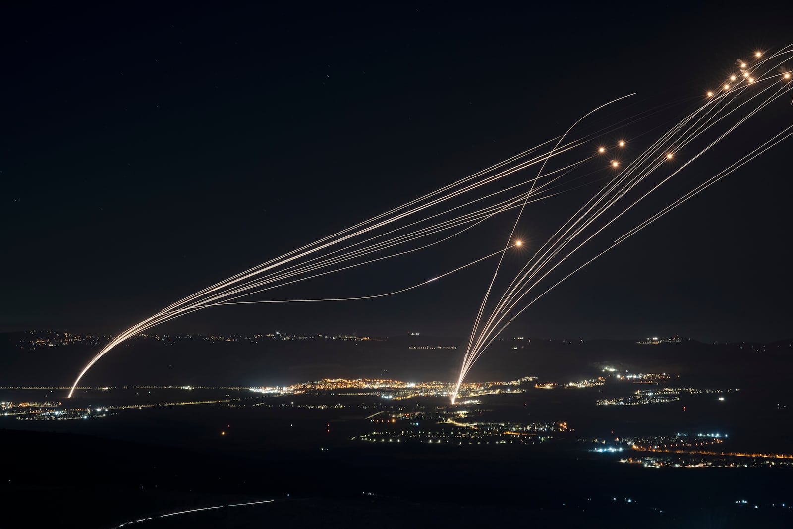 FILE - The Israeli Iron Dome air defense system fires to intercept an attack from Lebanon over the Galilee region as seen from the Israeli-annexed Golan Heights, on Aug. 4, 2024. (AP Photo/Leo Correa, File)