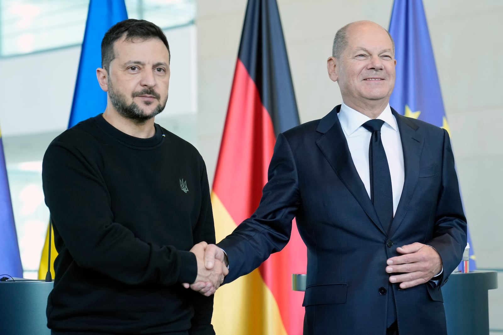 Ukraine's president Volodymyr Zelenskyy and German chancellor Olaf Scholz shake hands at the chancellery in Berlin, Germany, Friday, Oct. 11, 2024. (AP Photo/Ebrahim Noroozi)