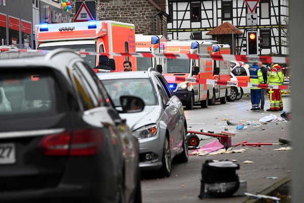 Emergency cars stand next to the scene of the accident with a car that is said to have crashed into a carnival parade in Volkmarsen, central Germany, Monday, Feb. 24, 2020. Several people have been injured, according to the police. The driver had been arrested by the police. (Uwe Zucchi/dpa via AP)