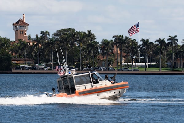 The U.S. flag is shown at Mar-a-Lago compound in Palm Beach, Fla., while a U.S. Coast Guard boat patrols around the vicinity, Monday, Jan. 13, 2025. U.S. flags at President-elect Donald Trump's private Mar-a-Lago club are back to flying at full height. Flags are supposed to fly at half-staff through the end of January out of respect for former President Jimmy Carter, who died Dec. 29. (AP Photo/Manuel Balce Ceneta)